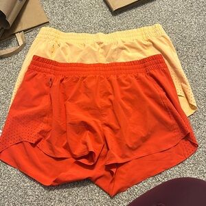 Bundle of TWO orange athleta hustle shorts 3”